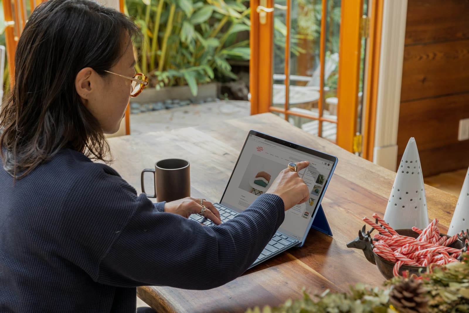 A shop owner checking her online store on a laptop